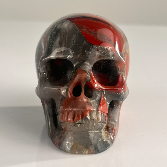 Front view of a 3-inch African Bloodstone human skull carving