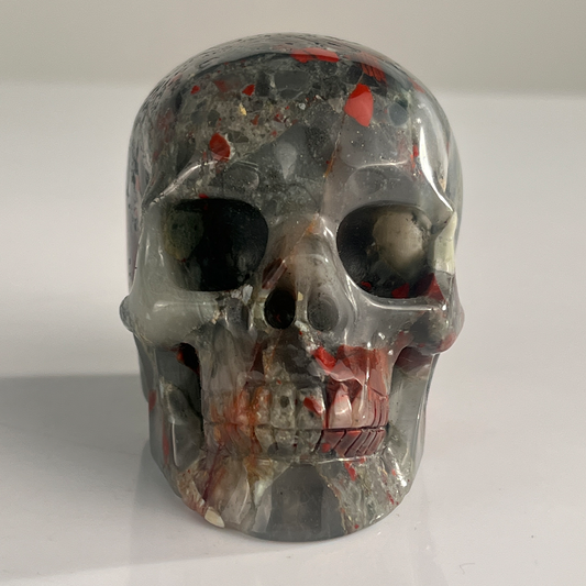 Front view of a 3-inch African Bloodstone human skull carving