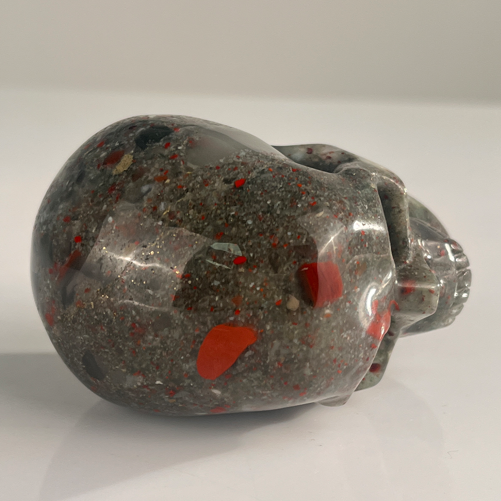 Top view of a 3-inch African Bloodstone human skull carving
