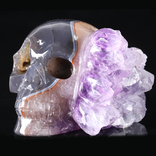 Left-front view of a 3-inch Amethyst cluster half-face skull carving