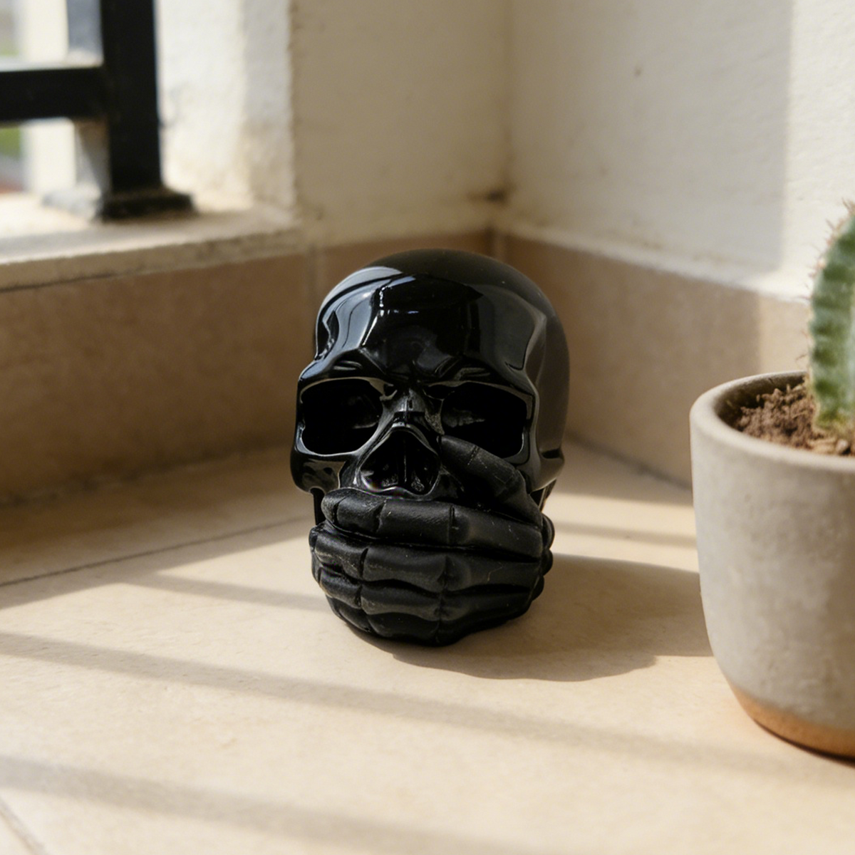 Additional view of a Black Obsidian Speak No Evil skull carving