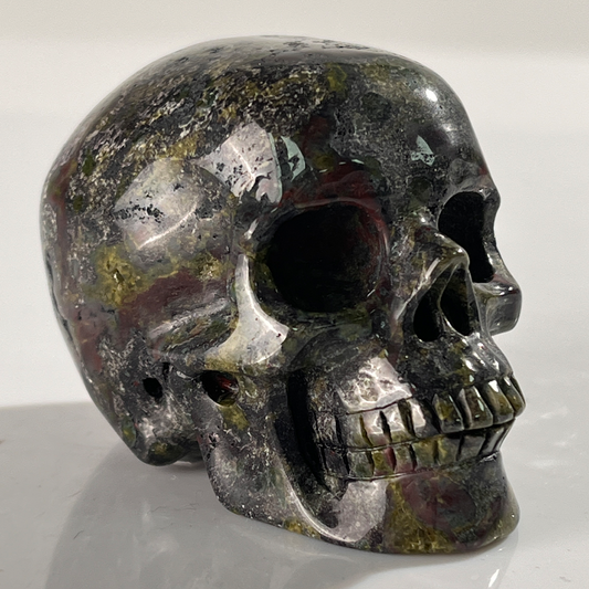 Right-front view of a 2-inch Dragon Bloodstone human skull carving