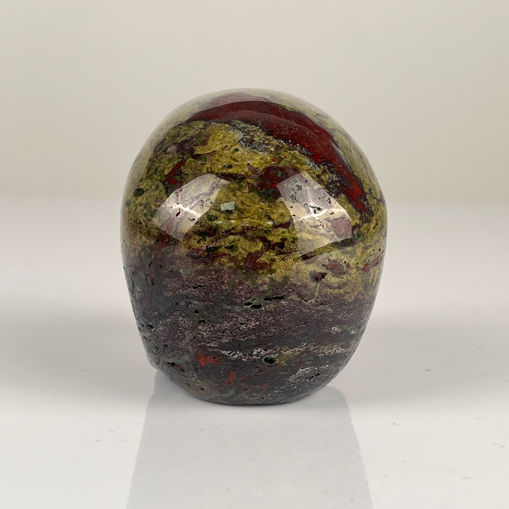 Back view of a 3-inch Dragon Bloodstone human skull carving