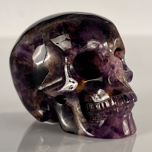 Right-front view of a 2-inch Dream Amethyst human skull carving