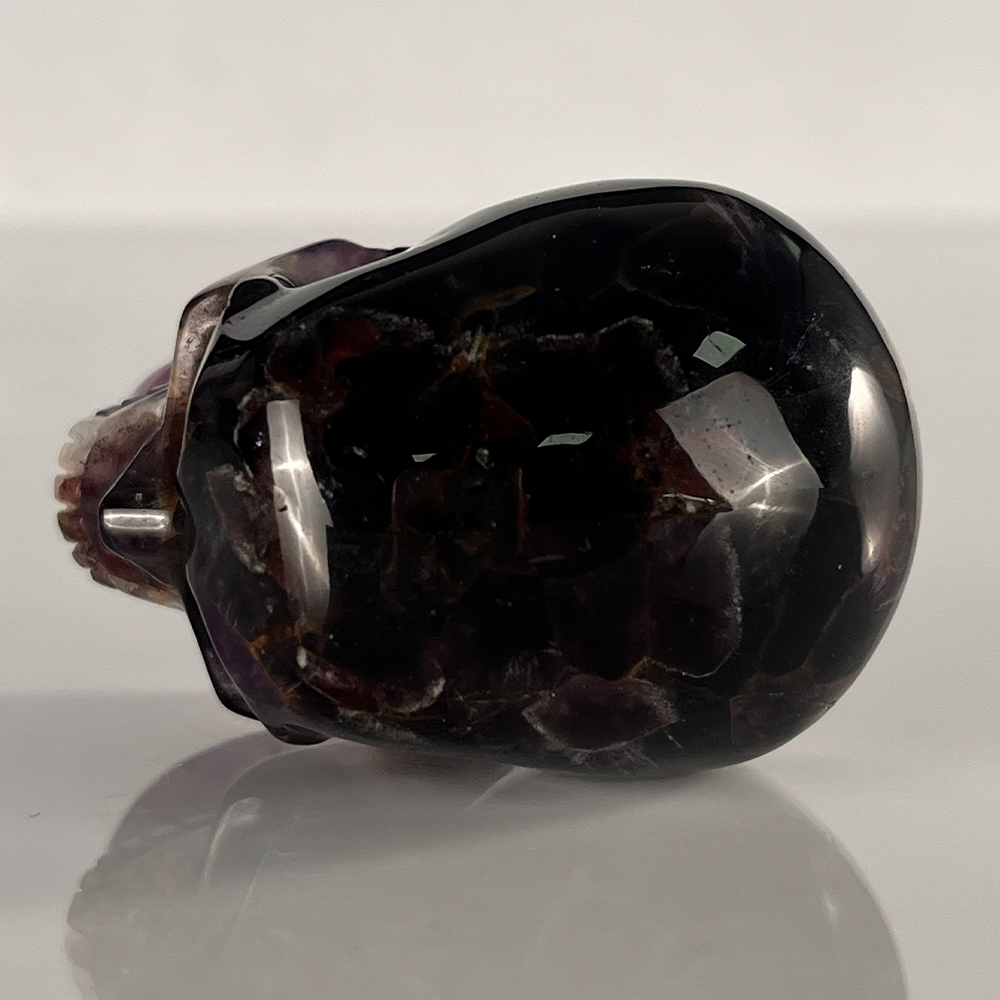 Top view of a 2-inch Dream Amethyst human skull carving
