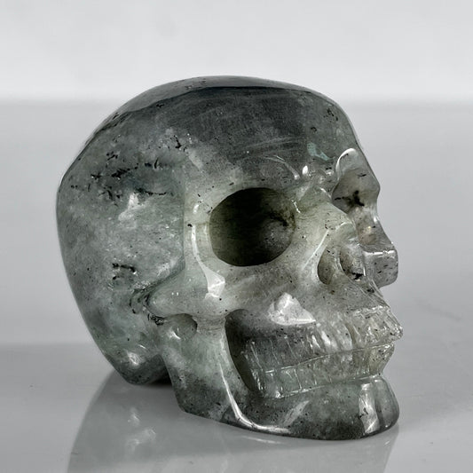 Right-front view of a 2-inch Grey Labradorite human skull carving