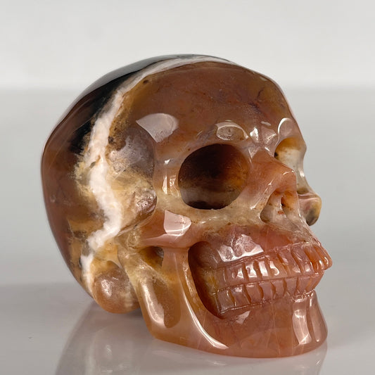 Right-front view of a 2-inch Yellow Chalcedony human skull carving