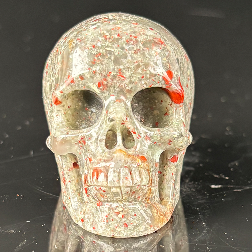 Front view of a 2-inch African Bloodstone human skull carving