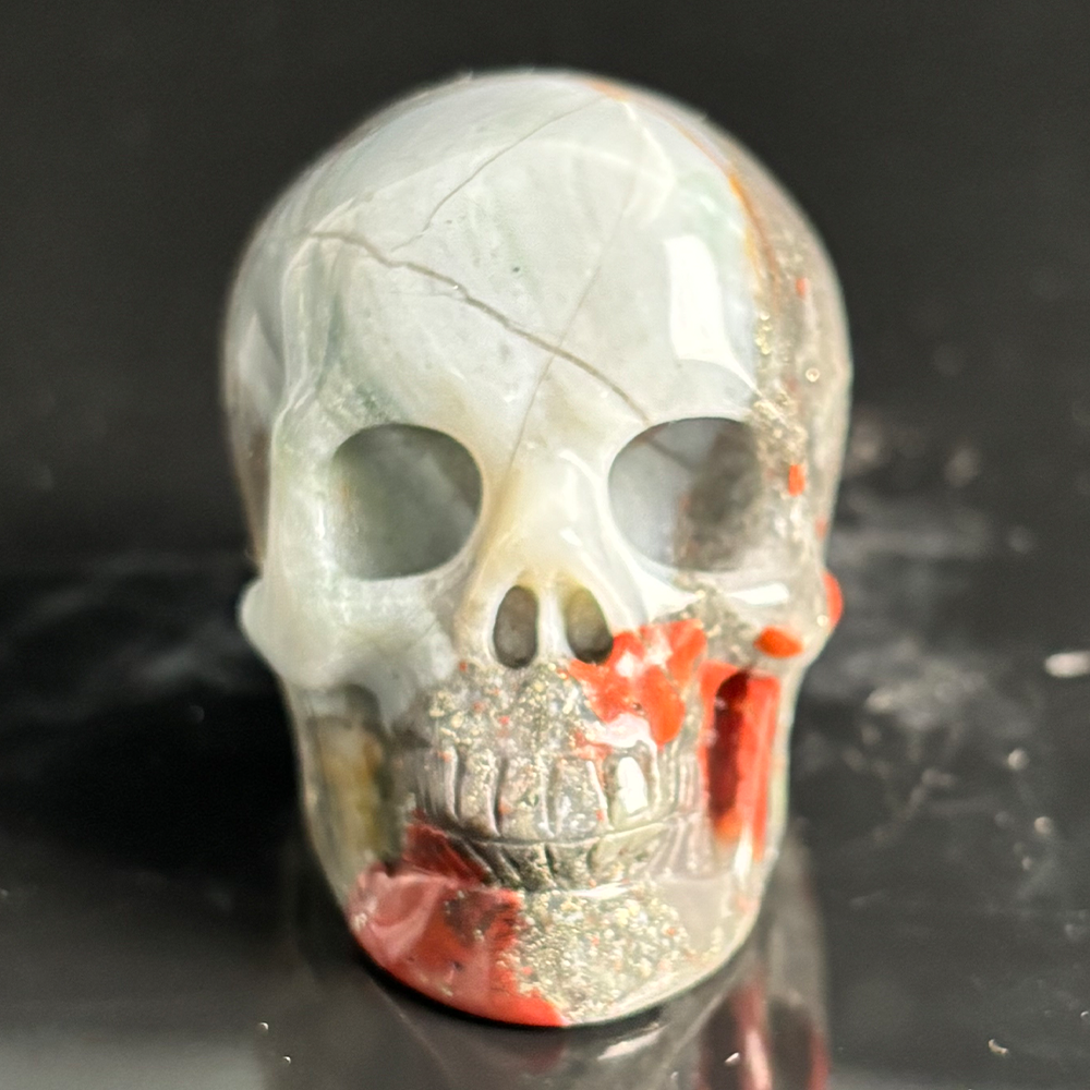 Front view of a 2-inch African Bloodstone human skull carving
