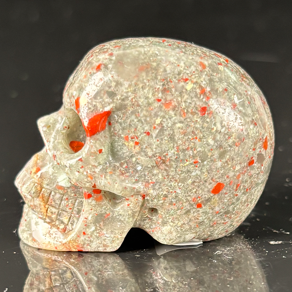 Left view of a 2-inch African Bloodstone human skull carving