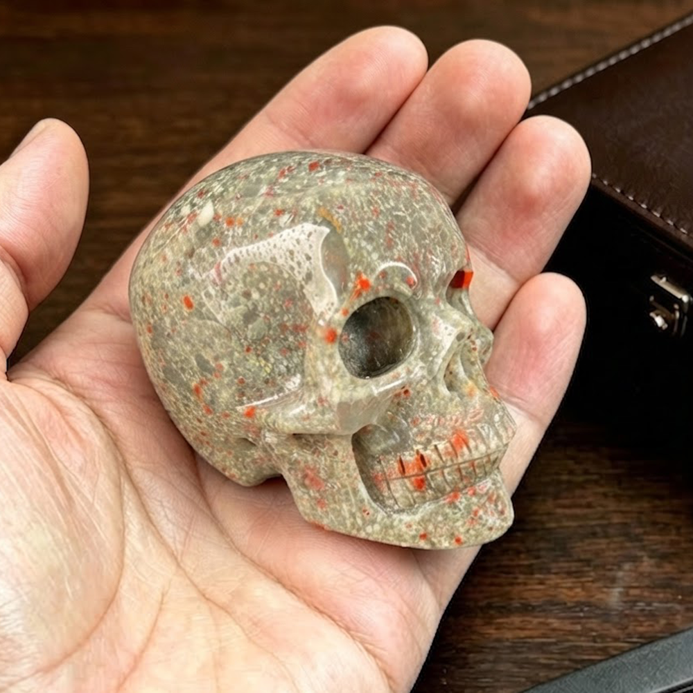 Main view of a 2-inch African Bloodstone human skull carving