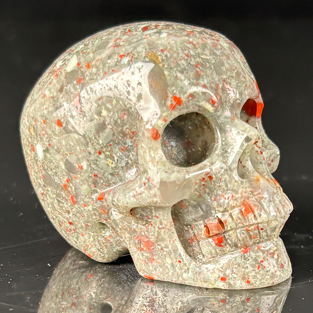 Right-front view of a 2-inch African Bloodstone human skull carving