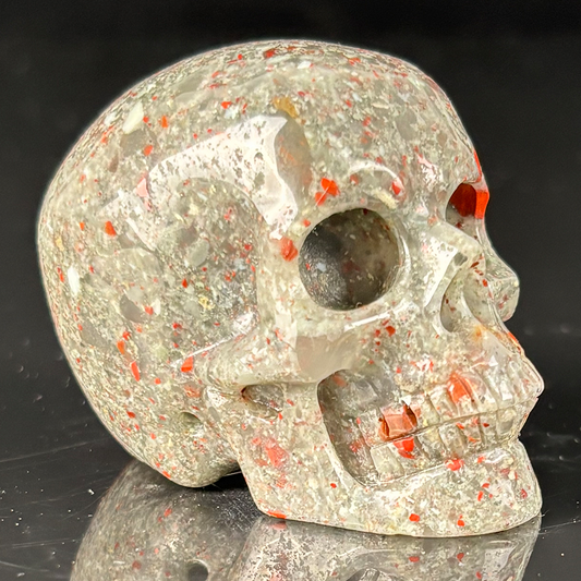 Right-front view of a 2-inch African Bloodstone human skull carving
