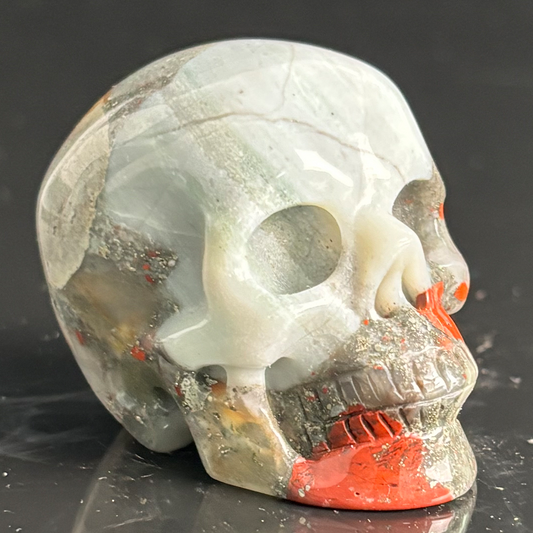 Right-front view of a 2-inch African Bloodstone human skull carving