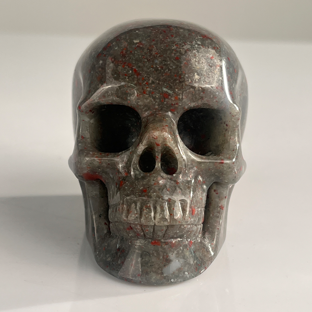 Front view of a 3-inch African Bloodstone human skull carving