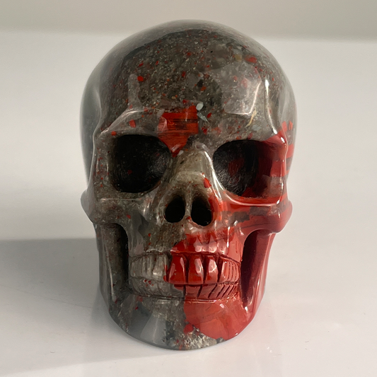 Front view of a 3-inch African Bloodstone human skull carving