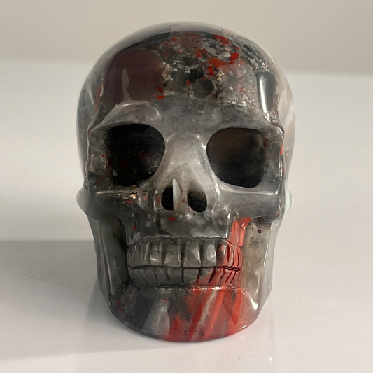 Front view of a 3-inch African Bloodstone human skull carving