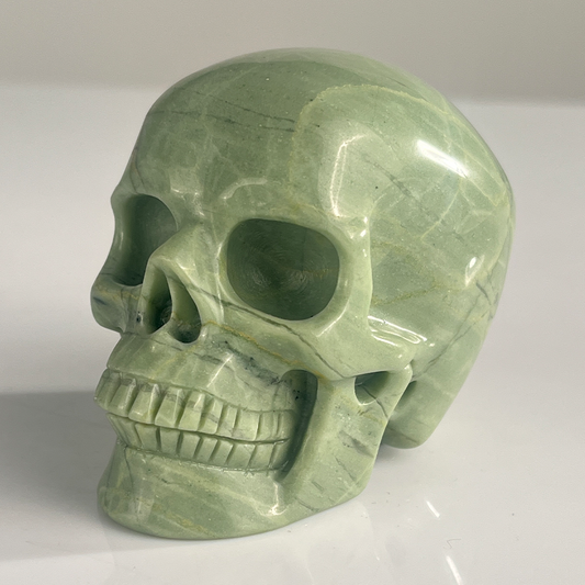 Left-front view of a 3-inch African Bloodstone human skull carving