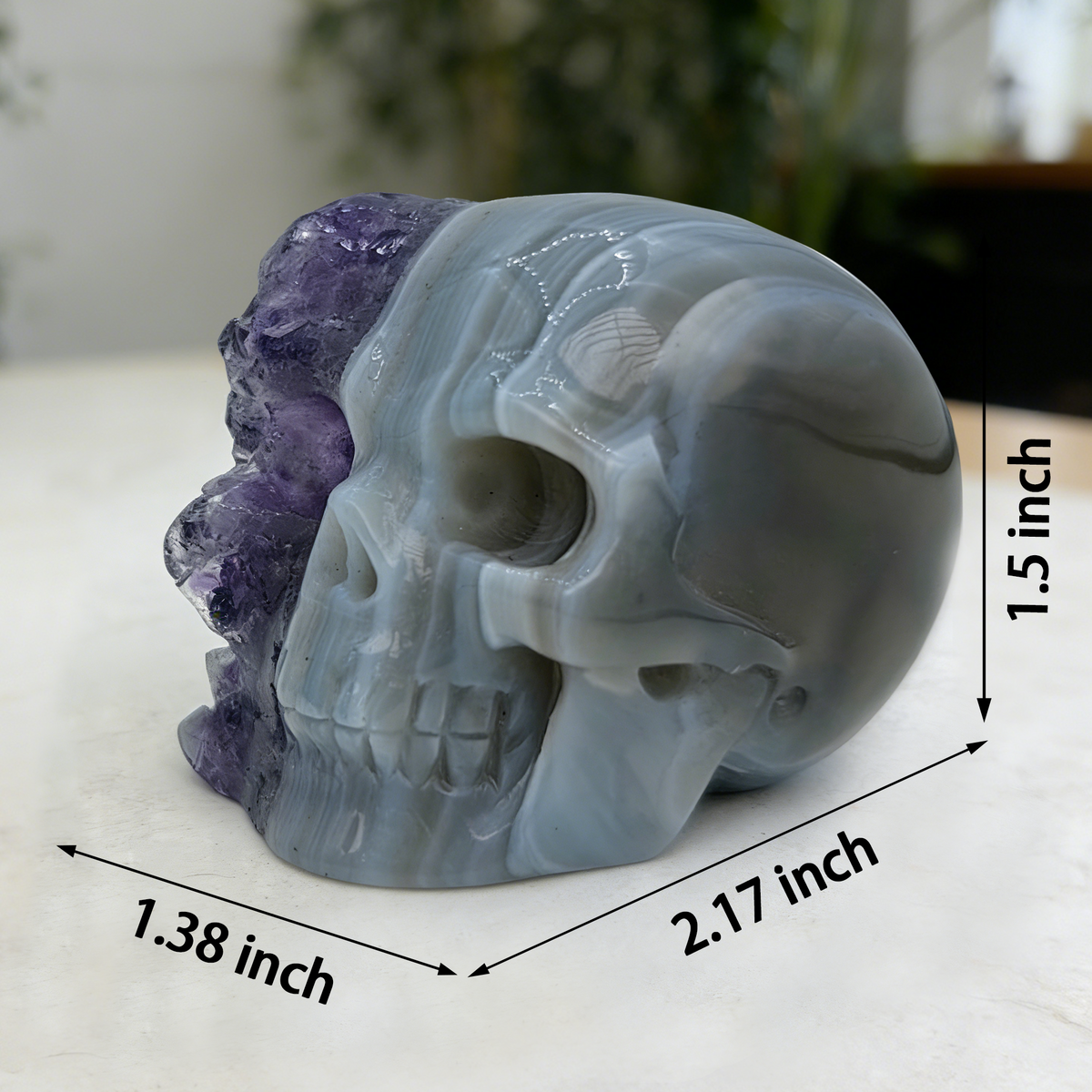 Additional view of a 2-inch Amethyst cluster half-face skull carving