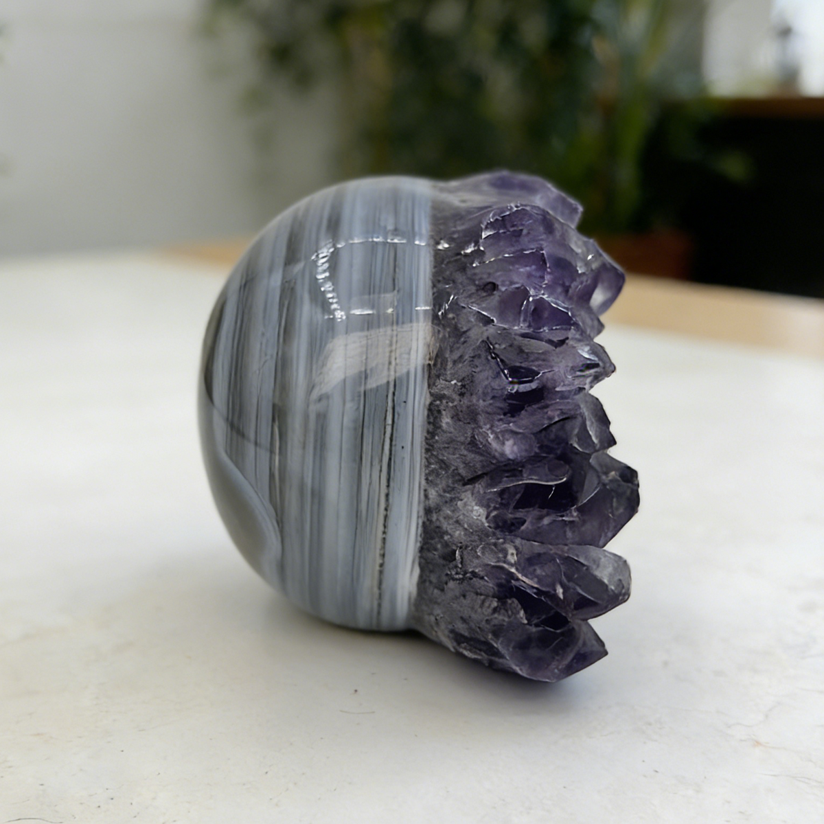Additional view of a 2-inch Amethyst cluster half-face skull carving
