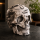 Right-front view of a 4.5-inch Black Crazy Lace Agate human skull carving