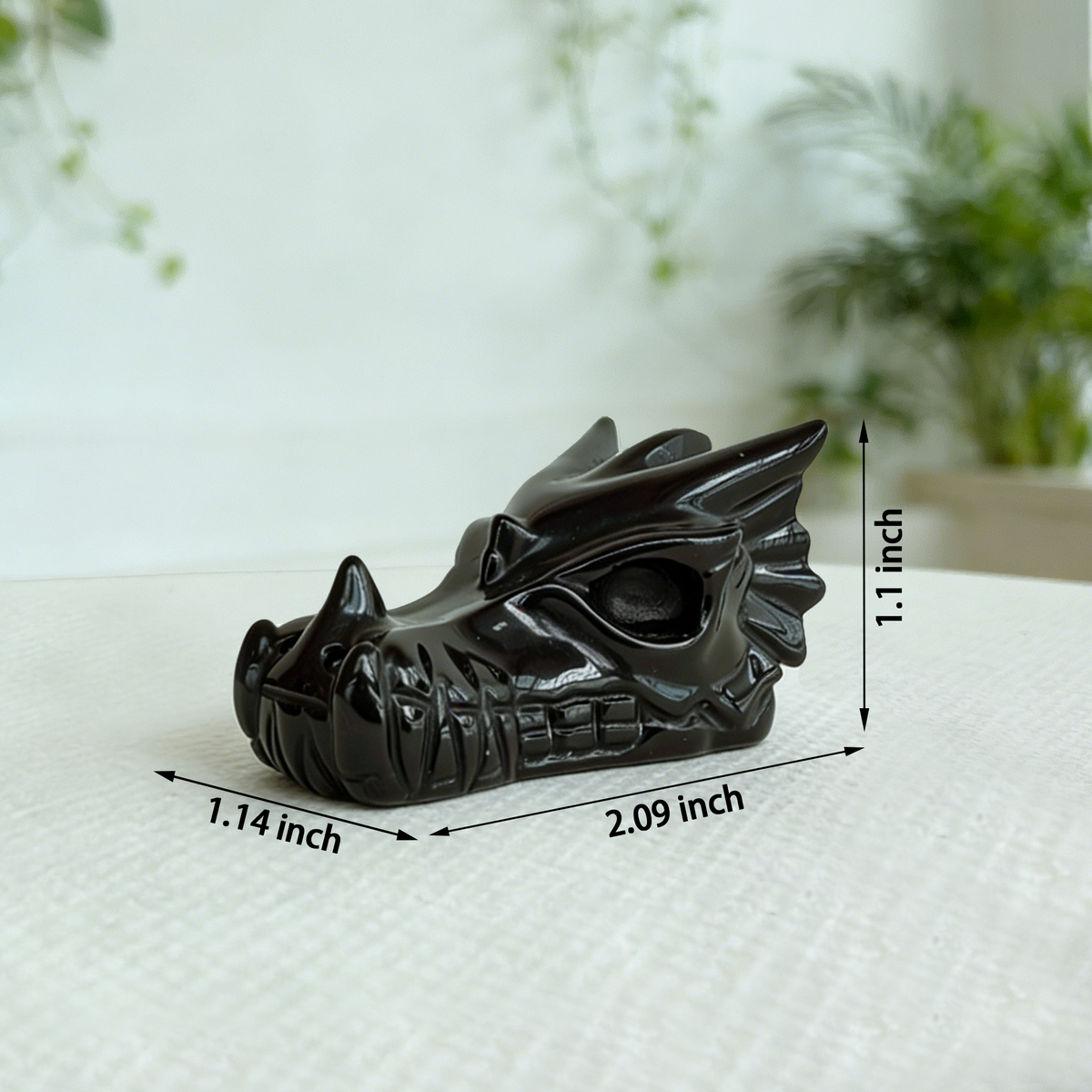 Additional view of a 2-inch Black Obsidian dragon skull carving