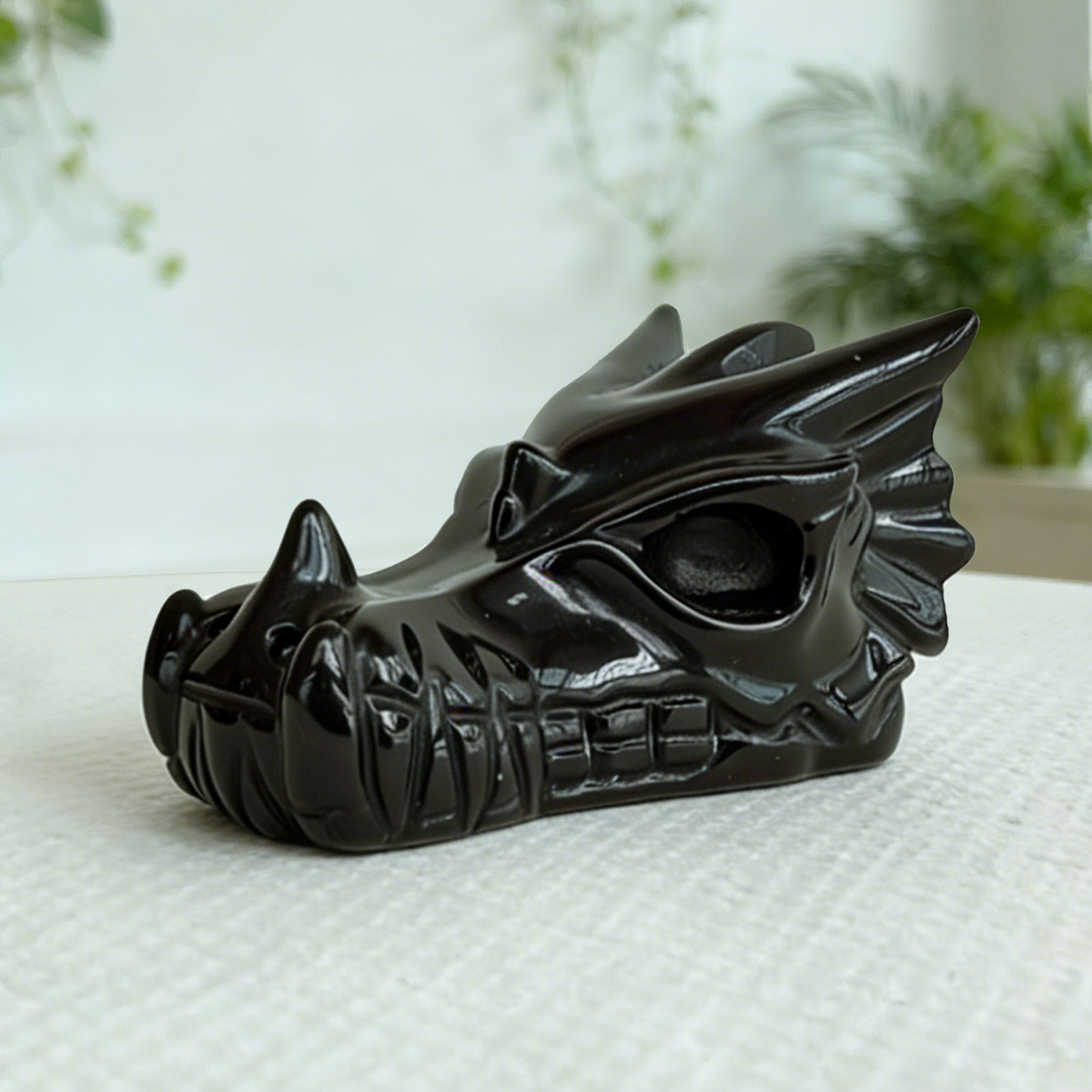 Additional view of a 2-inch Black Obsidian dragon skull carving
