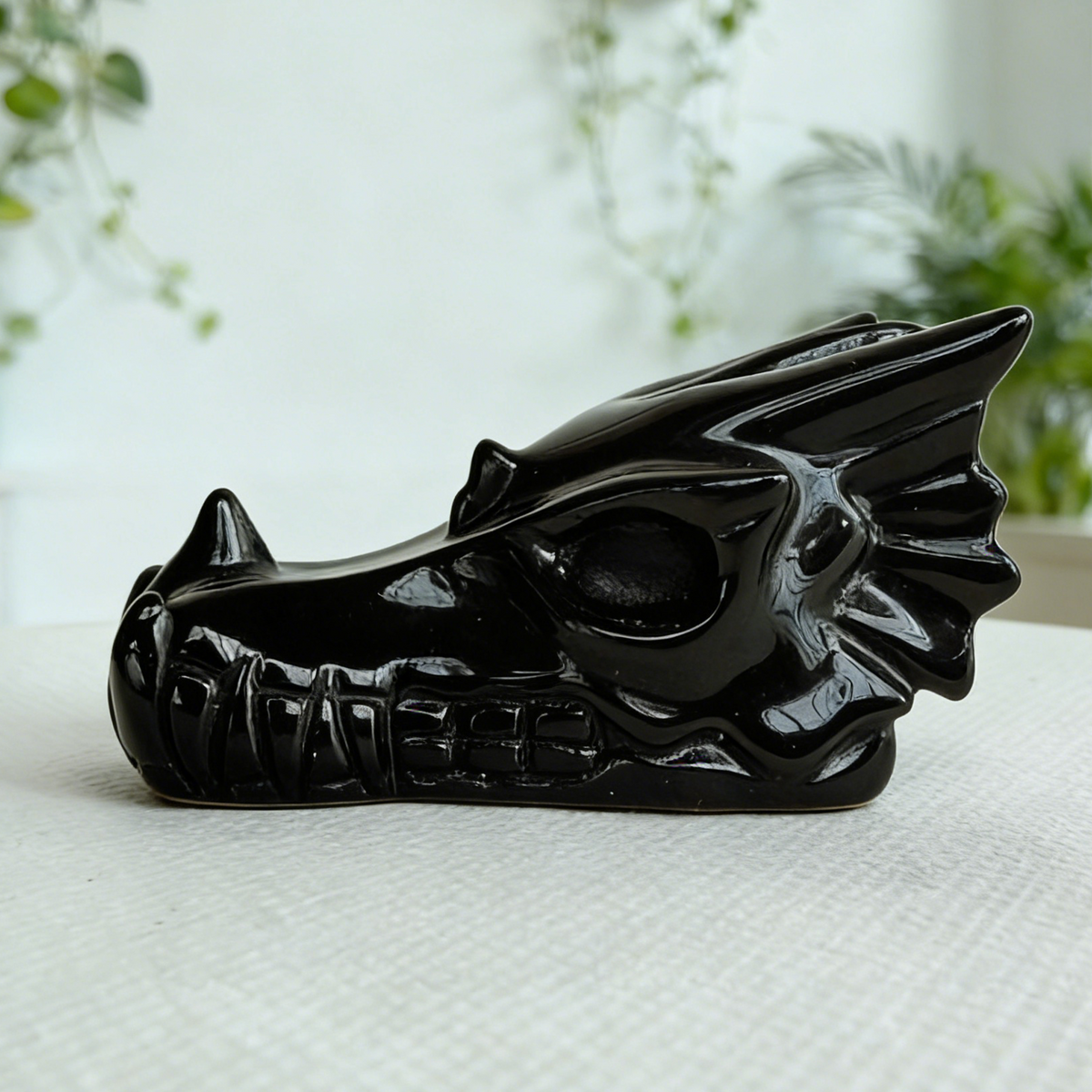 Additional view of a 2-inch Black Obsidian dragon skull carving