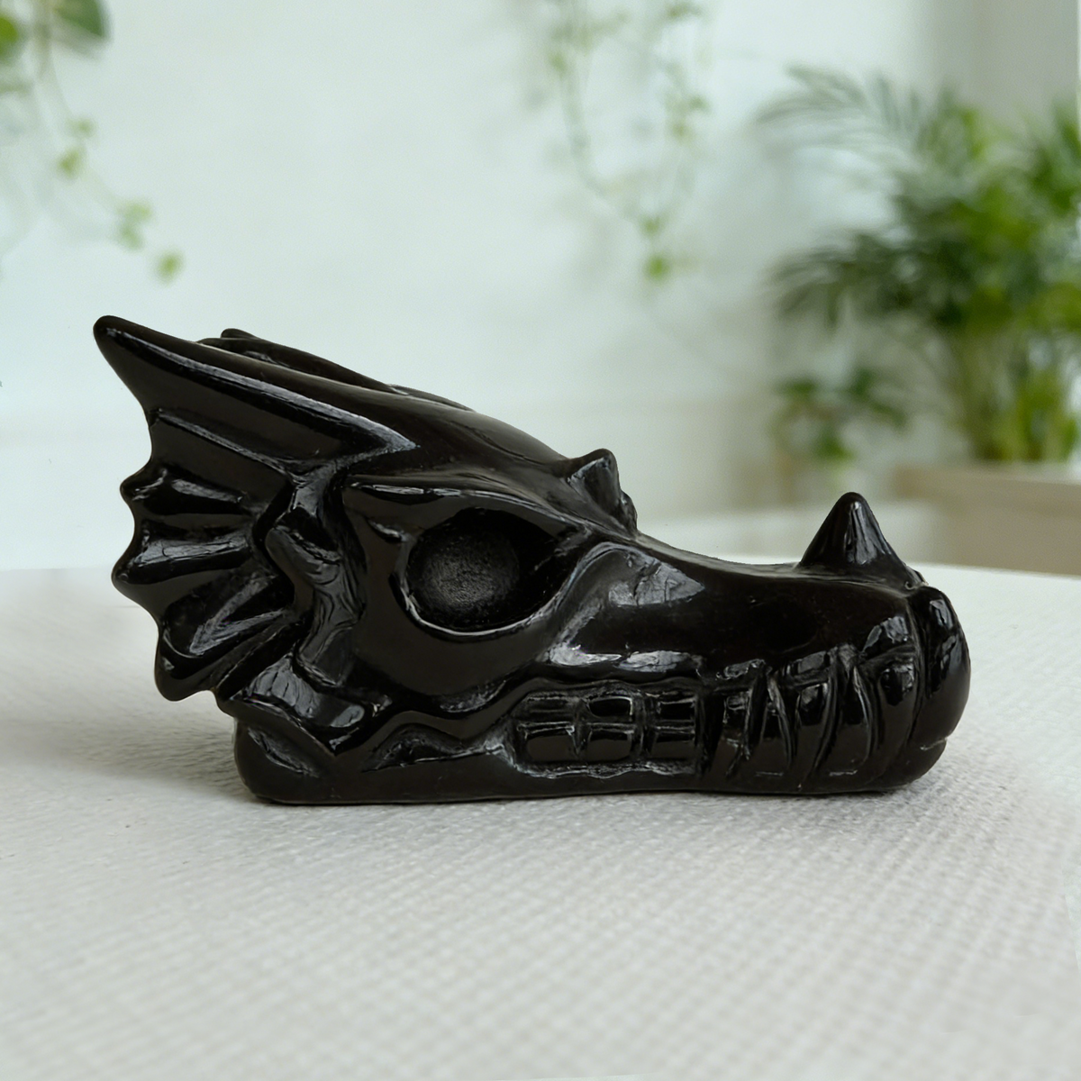 Additional view of a 2-inch Black Obsidian dragon skull carving