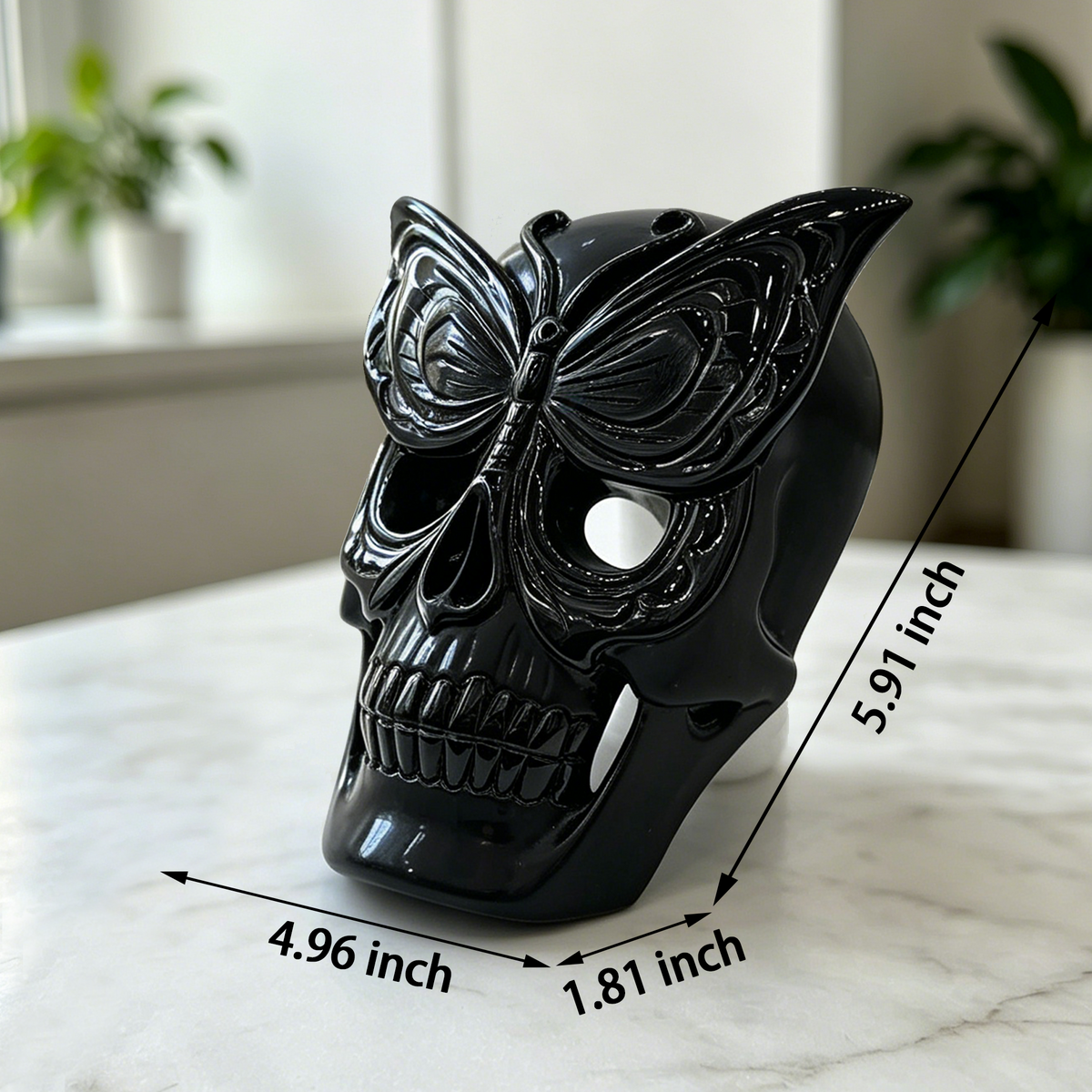 Additional view of a Black Obsidian skull with frosted butterfly mask sculpture