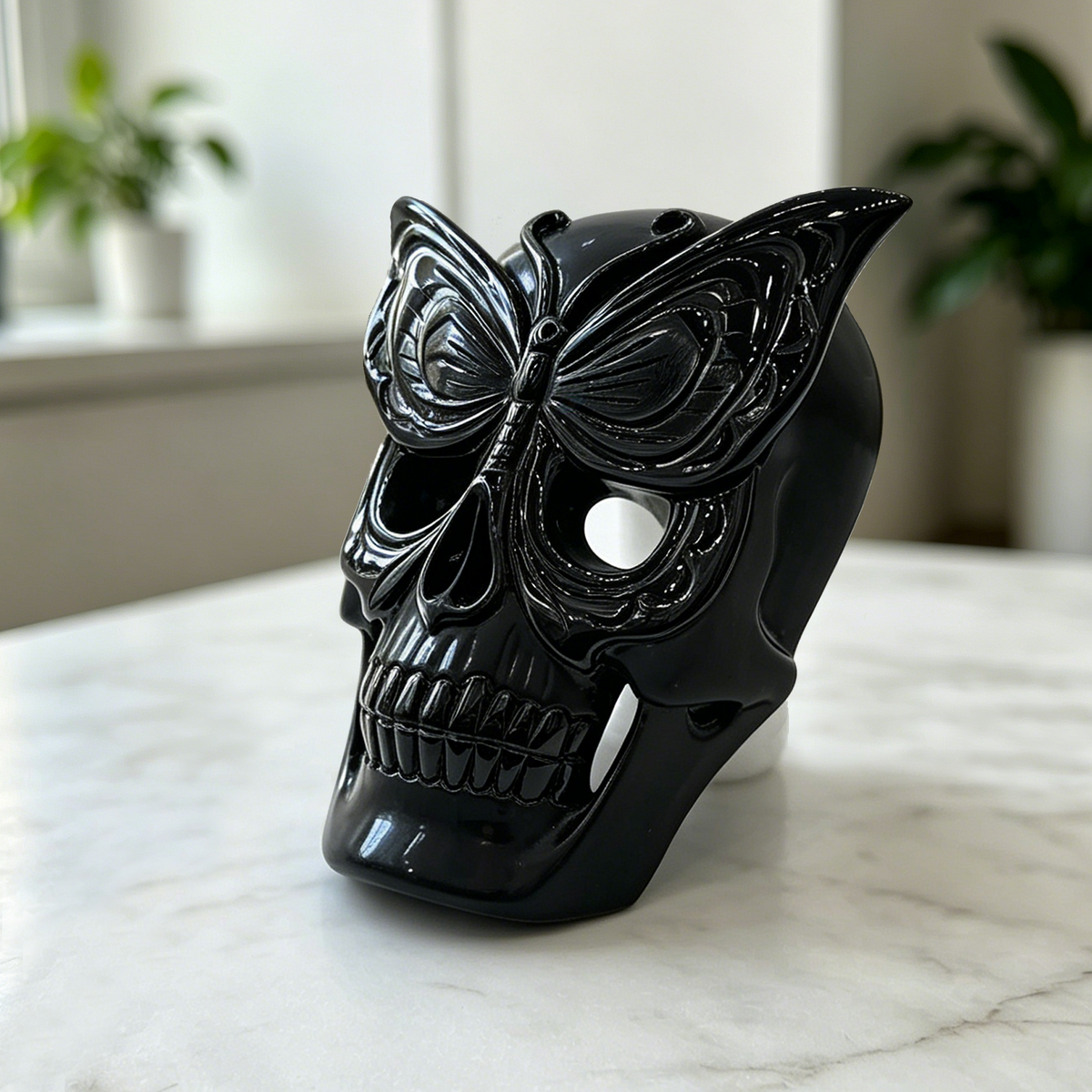 Additional view of a Black Obsidian skull with frosted butterfly mask sculpture