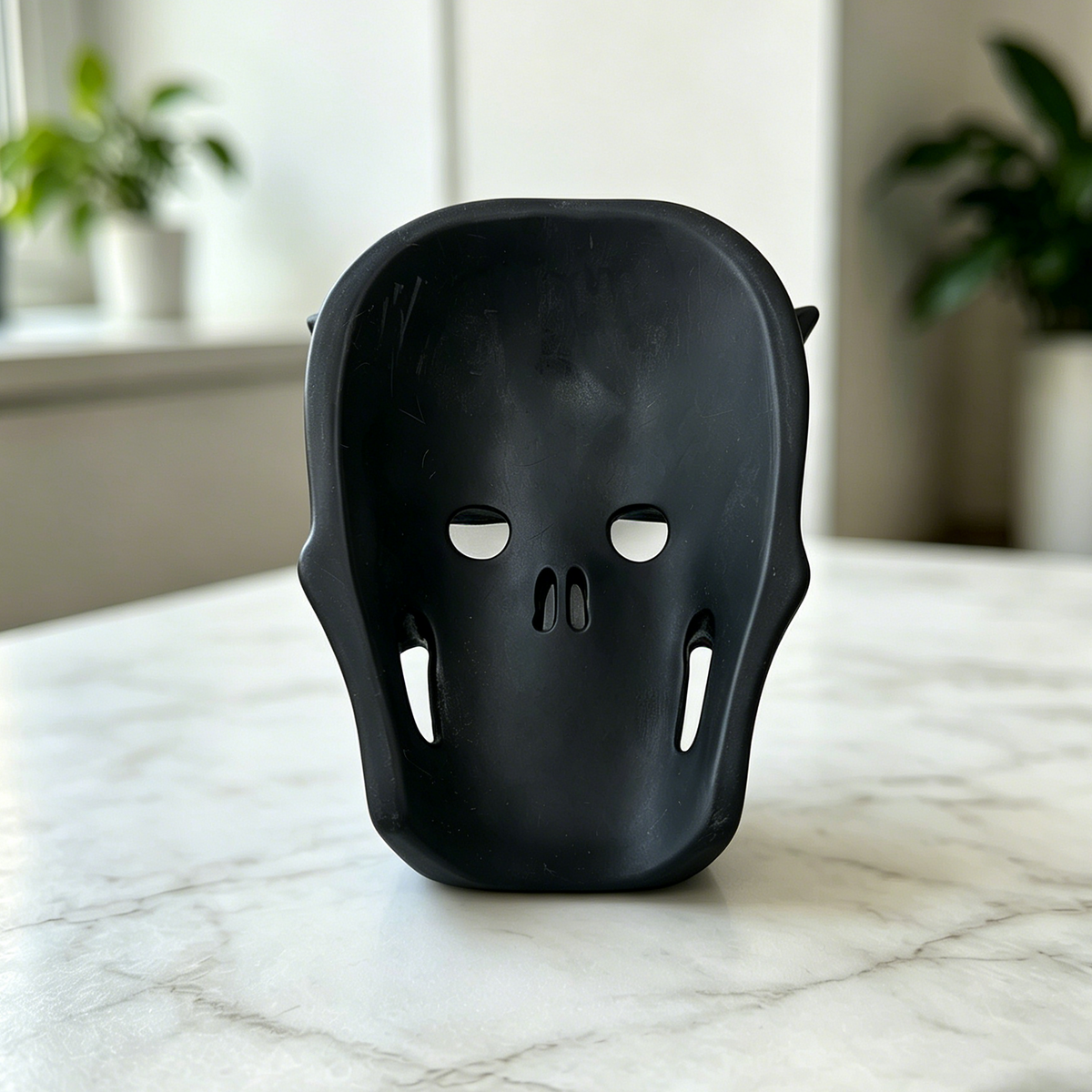 Additional view of a Black Obsidian skull with frosted butterfly mask sculpture