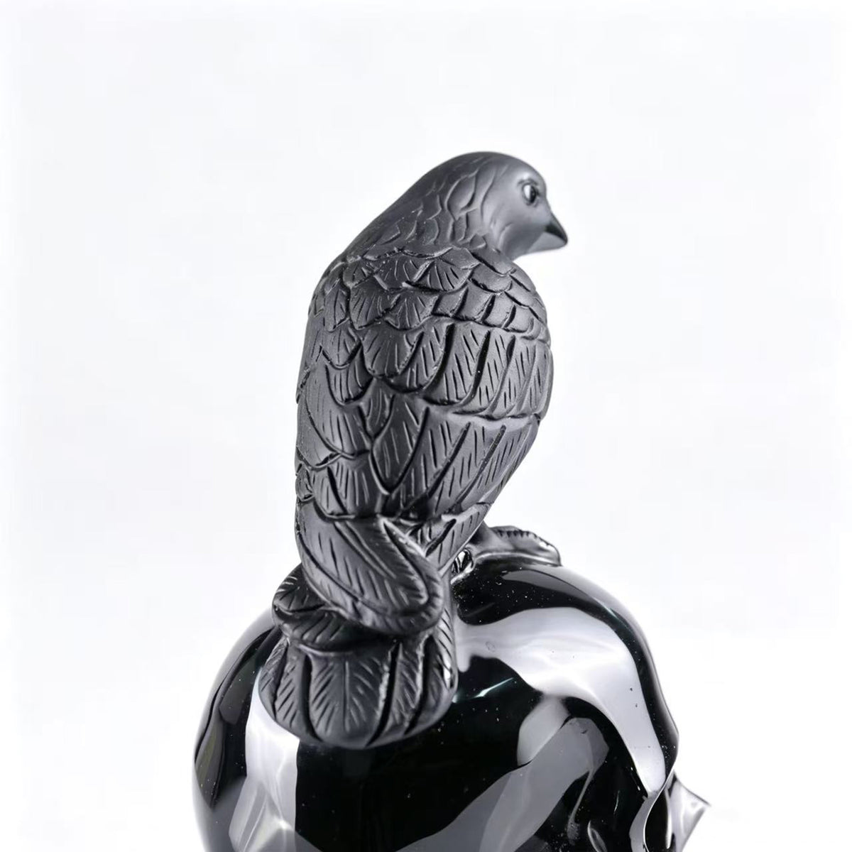 Additional view of a Black Obsidian skull and raven sculpture