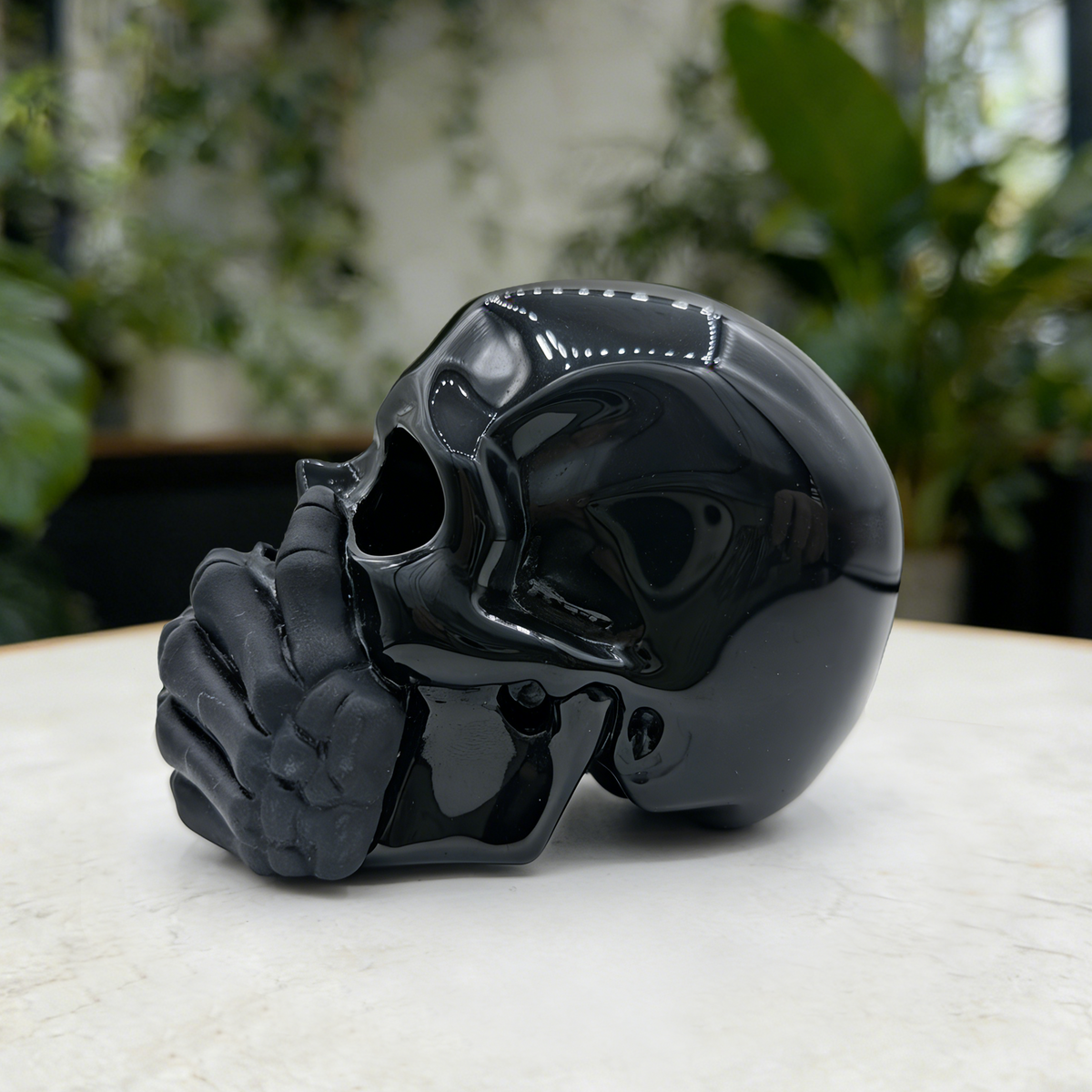 Additional view of a Black Obsidian Speak No Evil skull carving