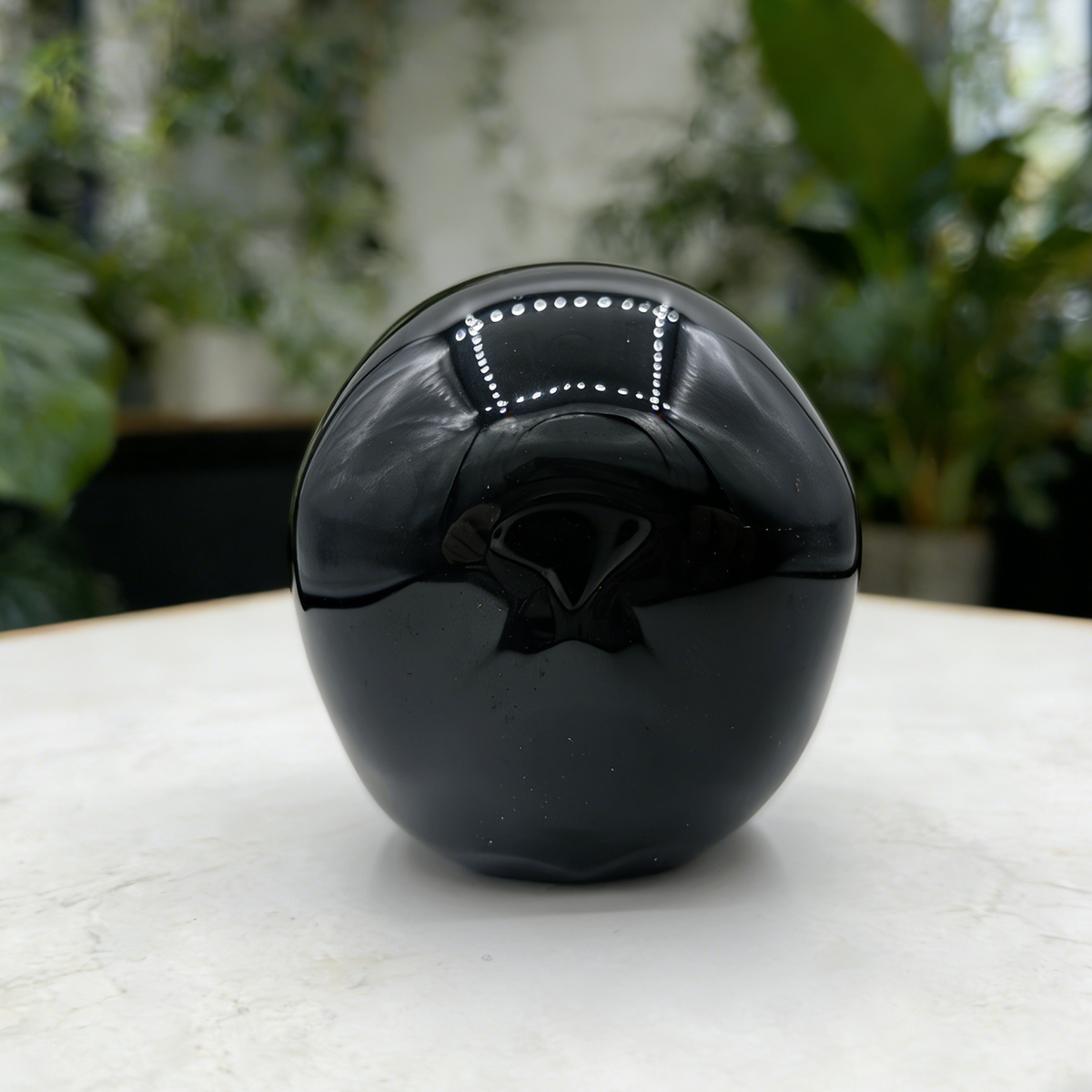 Additional view of a Black Obsidian Speak No Evil skull carving