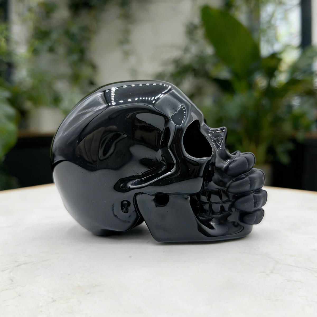 Additional view of a Black Obsidian Speak No Evil skull carving