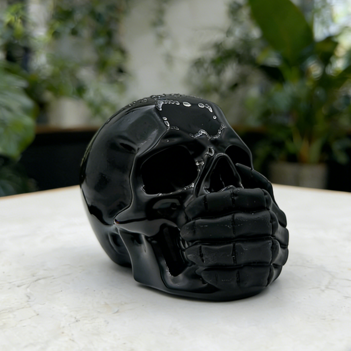 Additional view of a Black Obsidian Speak No Evil skull carving