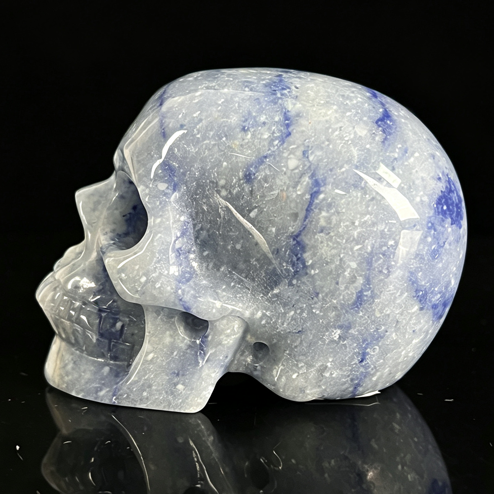 Left view of a 2-inch Blue Aventurine human skull carving