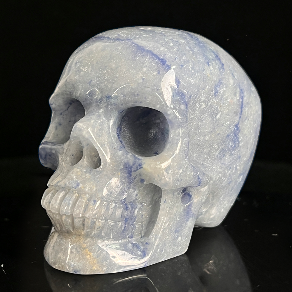 Left-front view of a 2-inch Blue Aventurine human skull carving