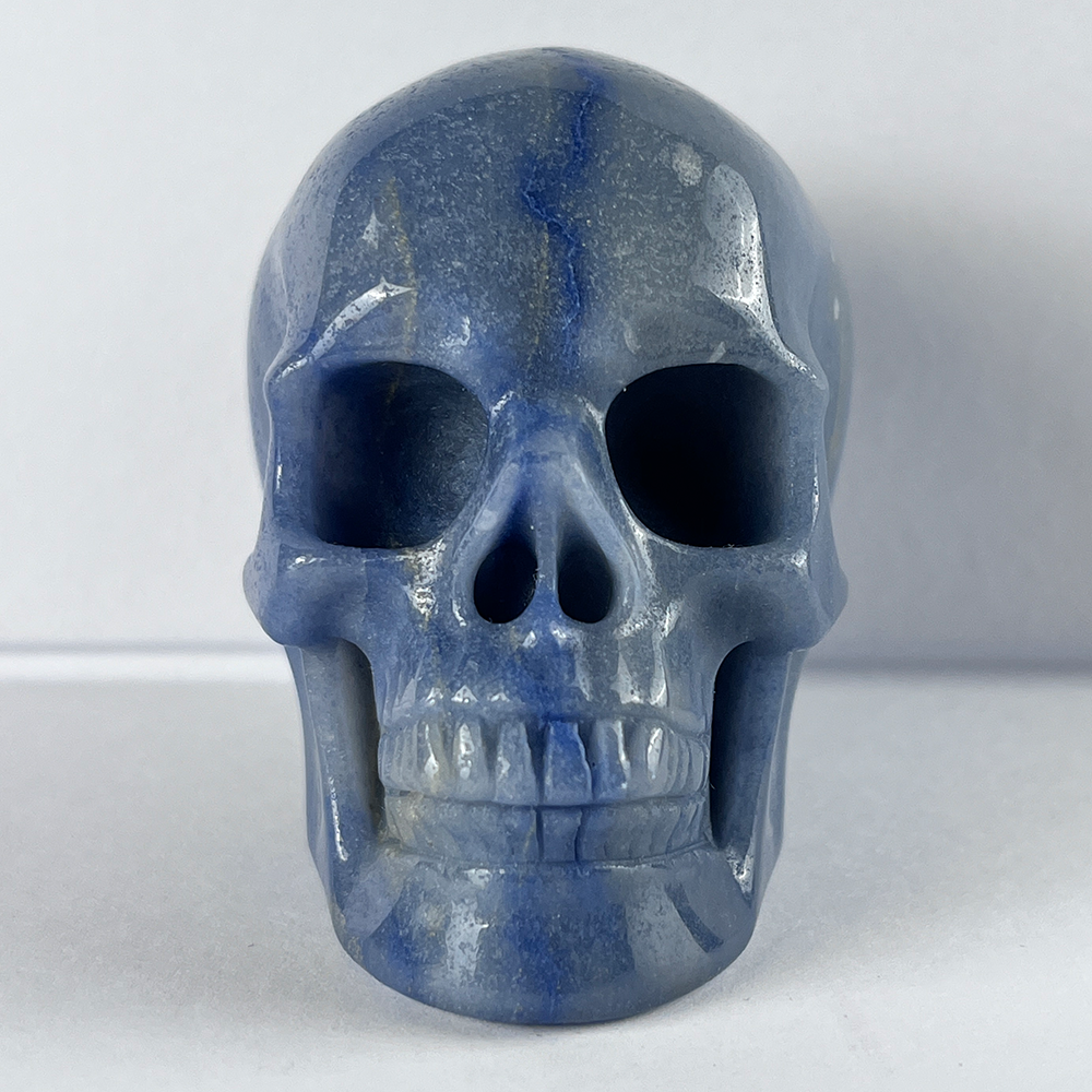 Front view of a 3-inch Blue Aventurine human skull carving