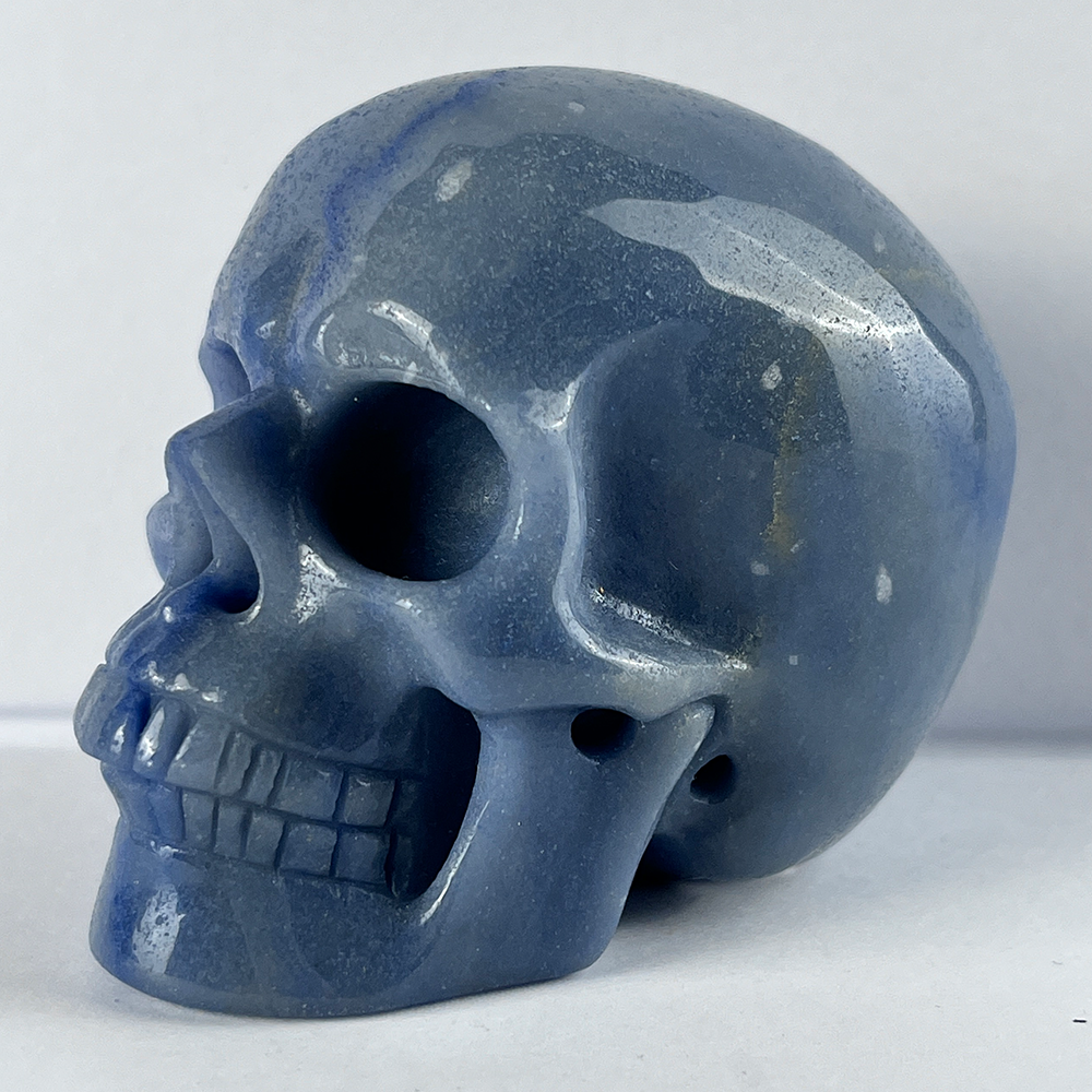 Left-front view of a 3-inch Blue Aventurine human skull carving