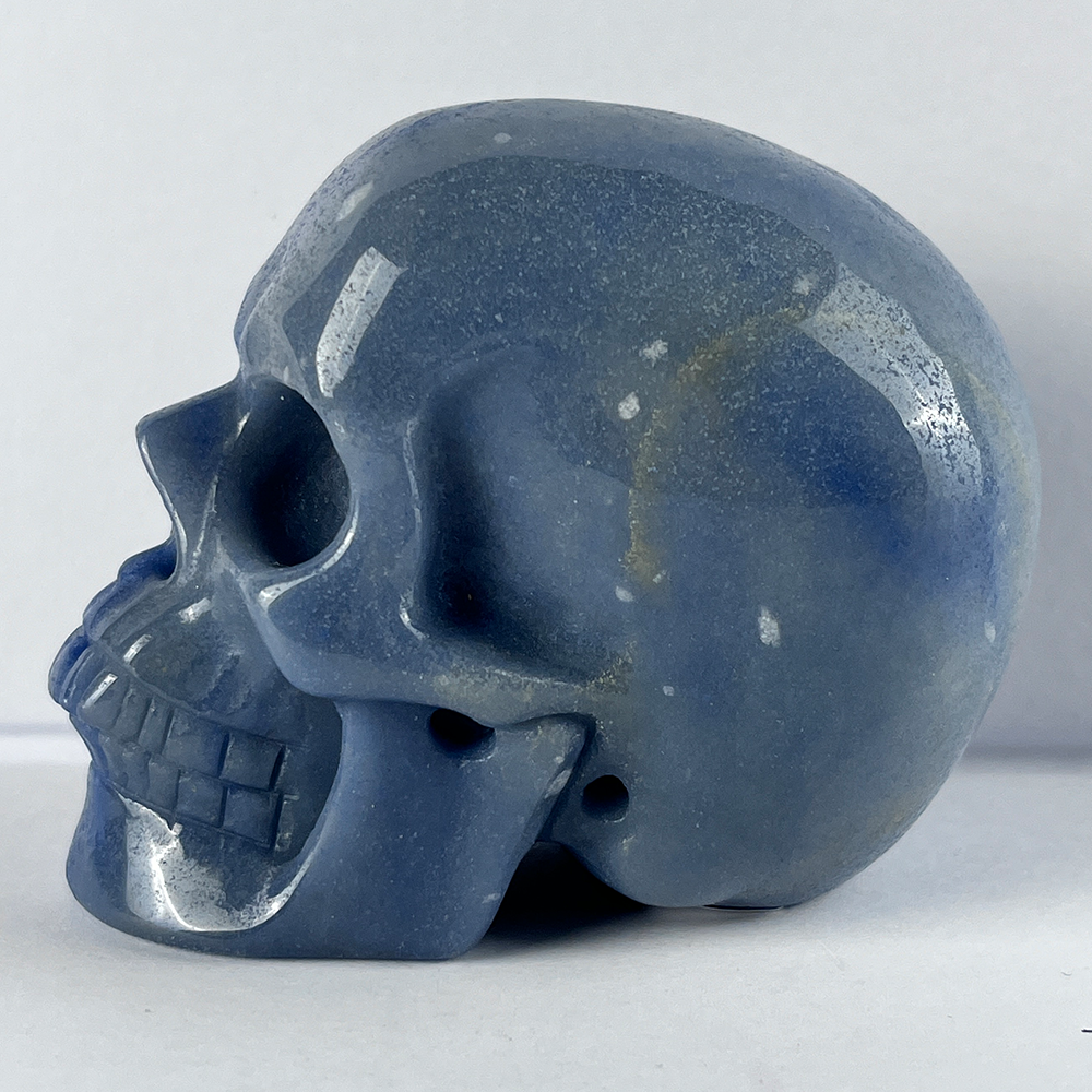 Left view of a 3-inch Blue Aventurine human skull carving