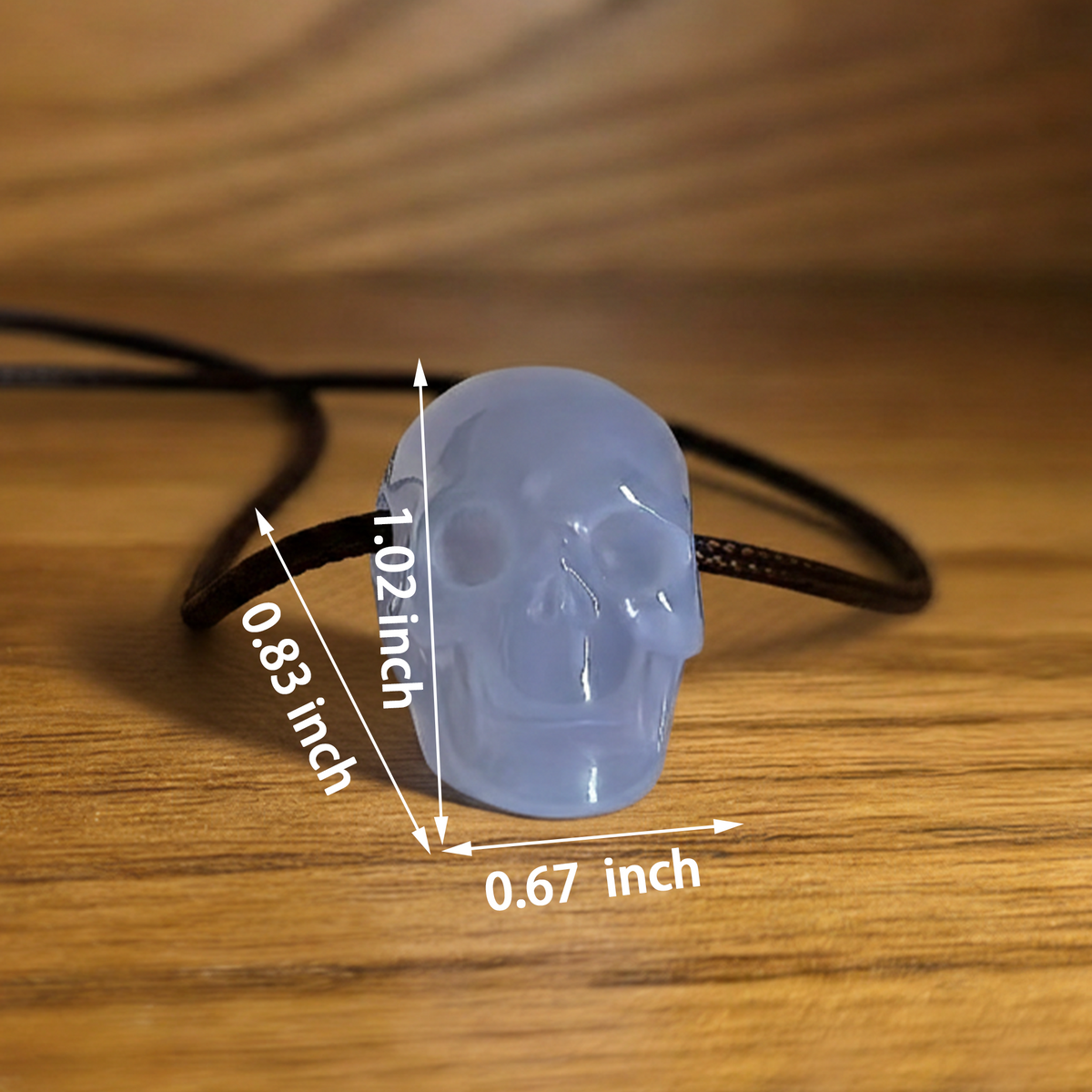 Additional view of a 1-inch Blue Chalcedony human skull pendant carving