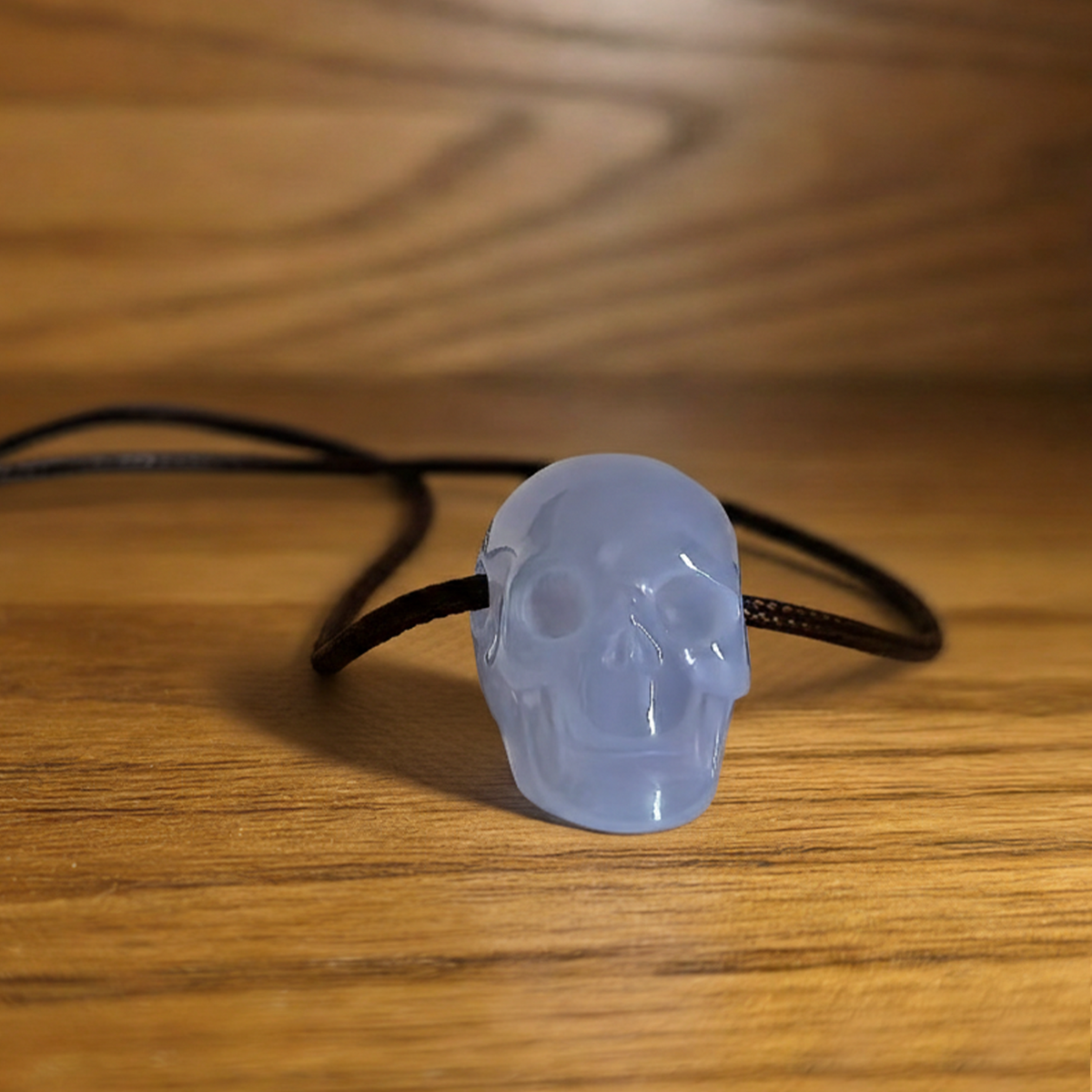 Additional view of a 1-inch Blue Chalcedony human skull pendant carving
