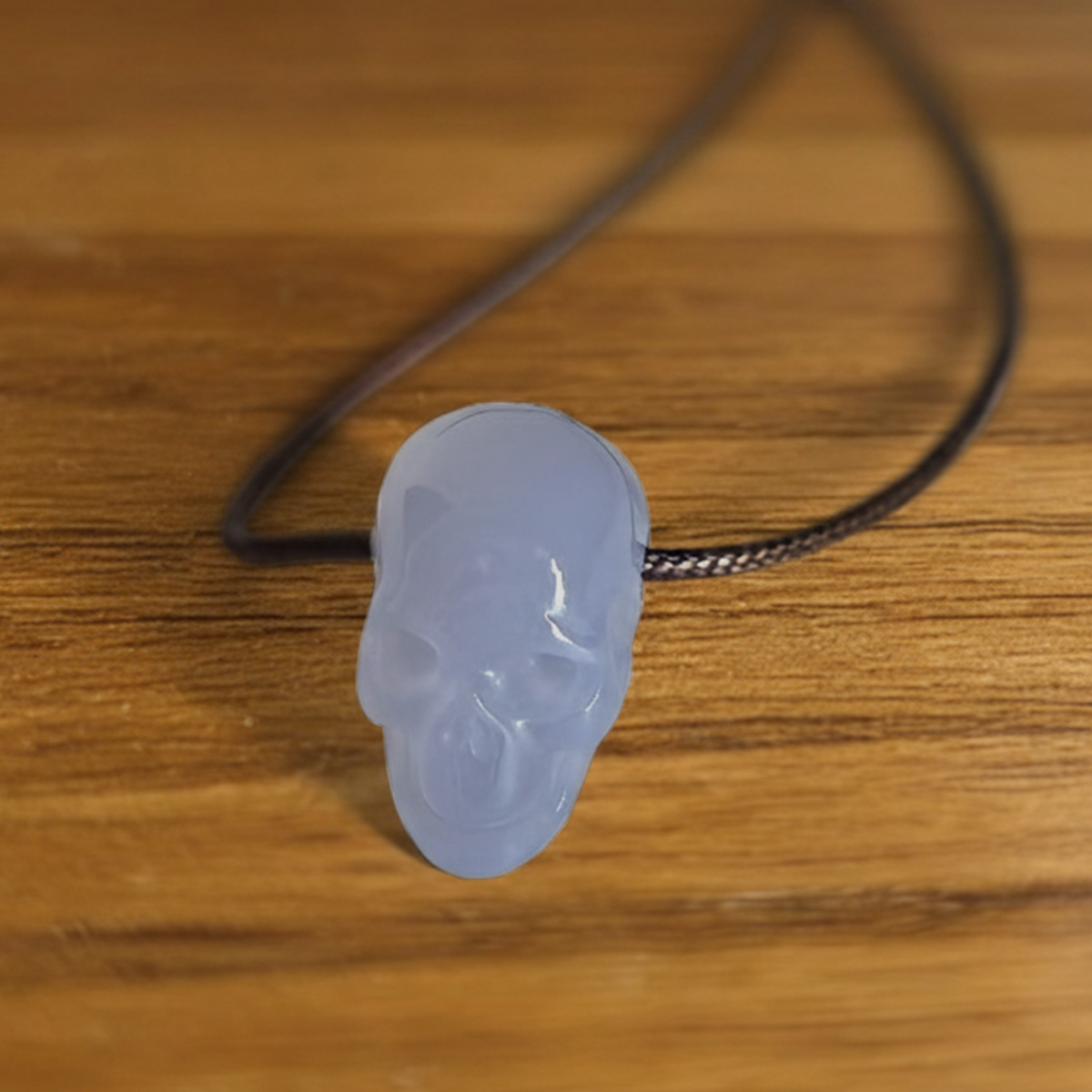 Additional view of a 1-inch Blue Chalcedony human skull pendant carving
