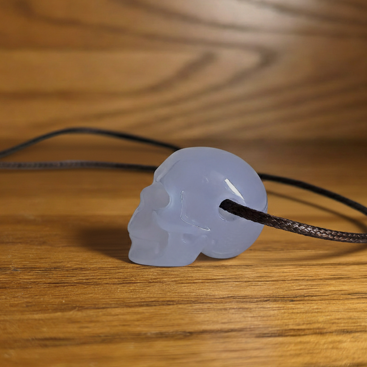 Additional view of a 1-inch Blue Chalcedony human skull pendant carving