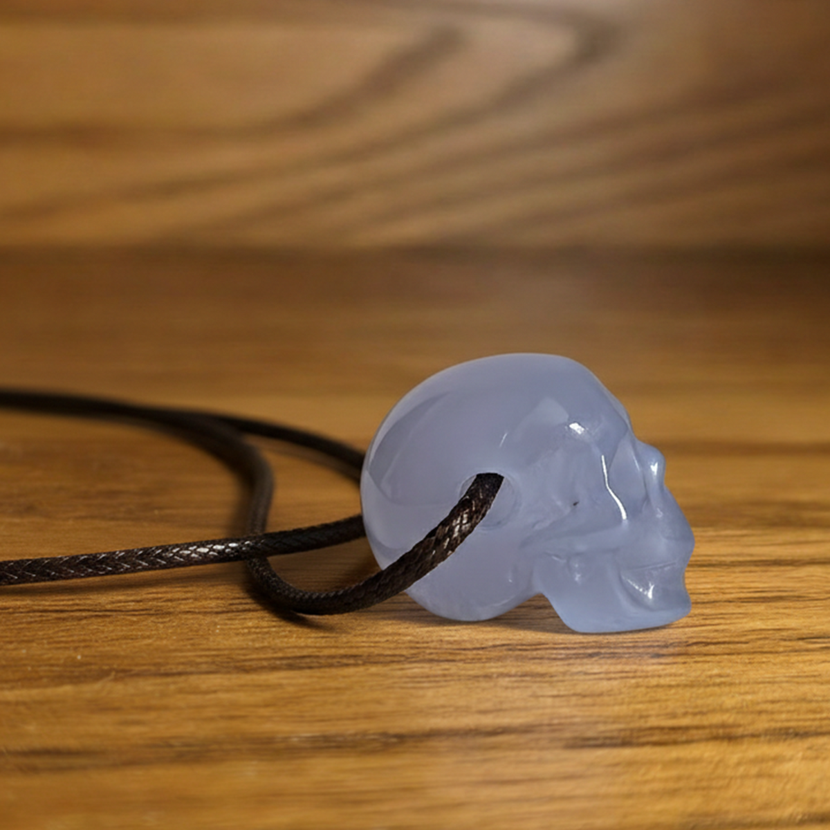 Additional view of a 1-inch Blue Chalcedony human skull pendant carving