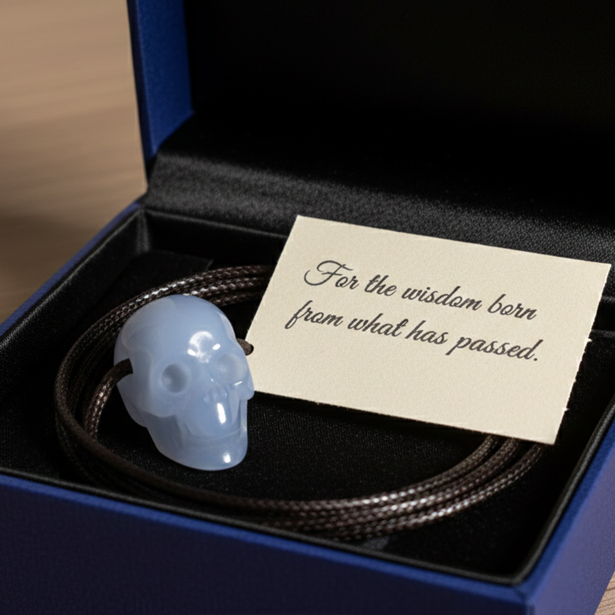 Additional view of a 1-inch Blue Chalcedony human skull pendant carving