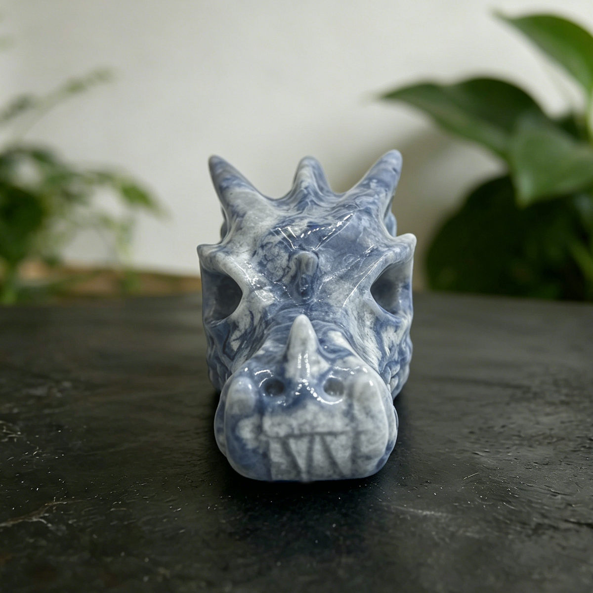 Additional view of a 2-inch Blue Flower Agate dragon skull carving