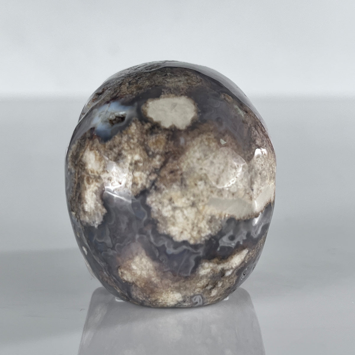 Back view of a 2-inch Blue Flower Agate human skull carving